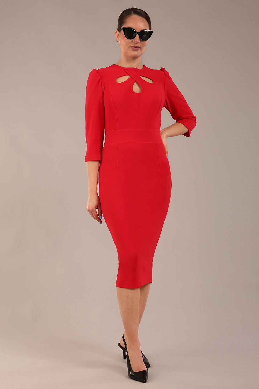 model is wearing a diva catwalk Quintessa Three Petal Keyhole Pencil Dress with 3/4 sleeves round neckline a below the knee length in red colour