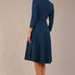brunette model is wearing a diva catwalk Haddington sleeved A-line Dress knee length round neckline with crossover v-slit detail in teal colour back image