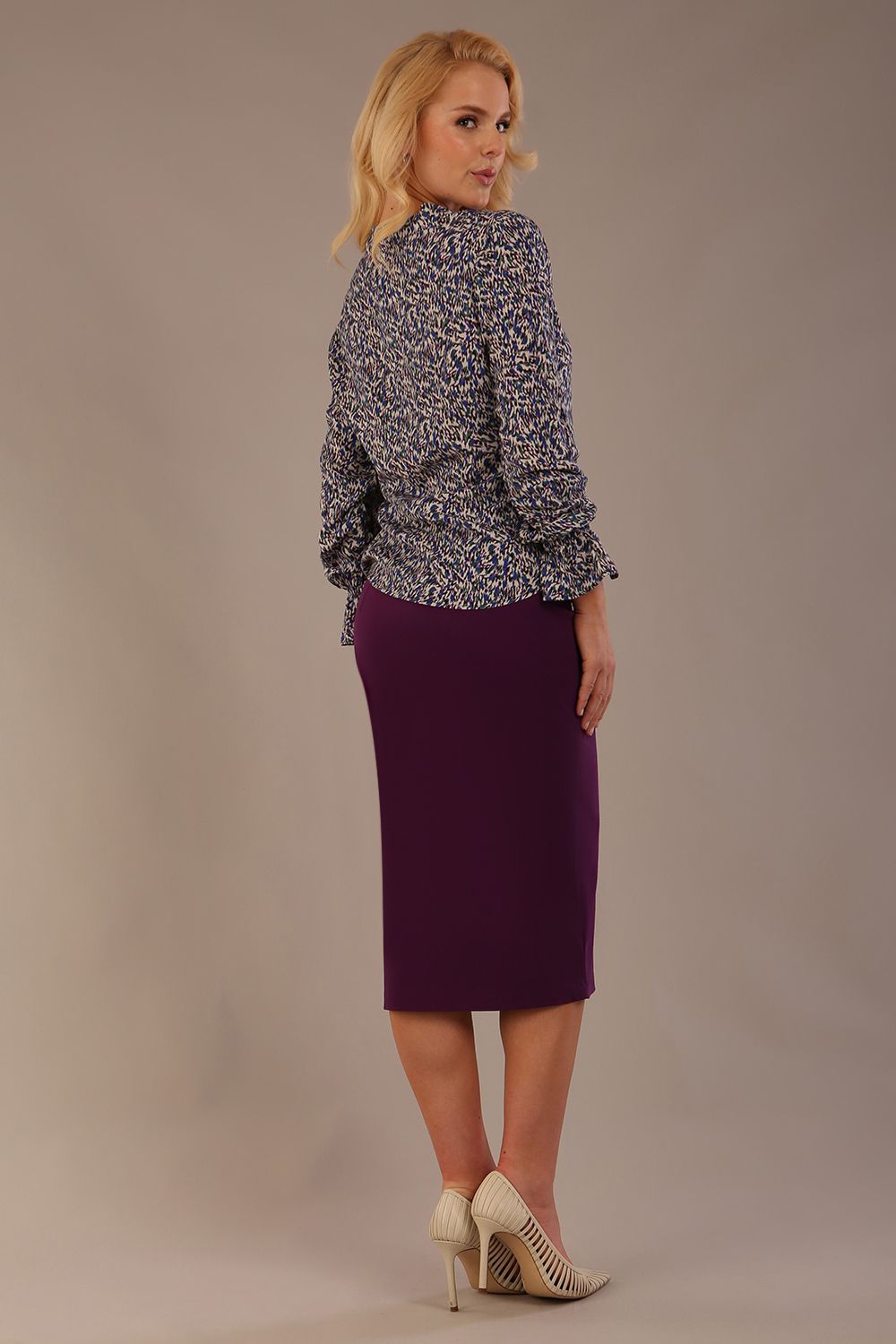 Profile view of the model wearing the Alpha top, highlighting the fit and long sleeves.