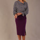 Close-up of the asymmetric neckline and fixed tie detail of the Alpha top, showing the fabric print and texture.