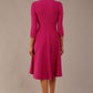 brunette model is wearing a diva catwalk Haddington sleeved A-line Dress knee length round neckline with crossover v-slit detail in magenta colour back image 