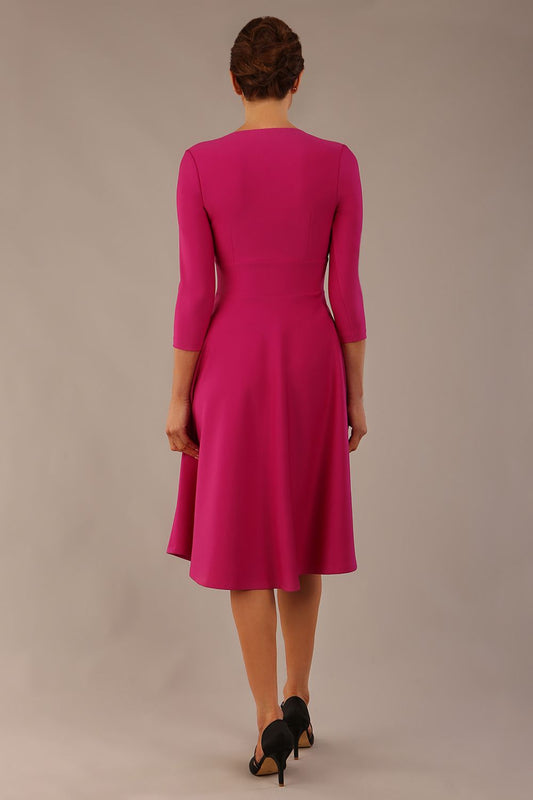 brunette model is wearing a diva catwalk Haddington sleeved A-line Dress knee length round neckline with crossover v-slit detail in magenta colour back image 
