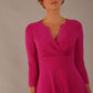 brunette model is wearing a diva catwalk Haddington sleeved A-line Dress knee length round neckline with crossover v-slit detail in magenta colour front image close up