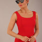 brunette model is wearing a diva catwalk Perthshire Sleeveless Bodycon Pencil Dress square neckline in passion red colour front image close up with sunglasses