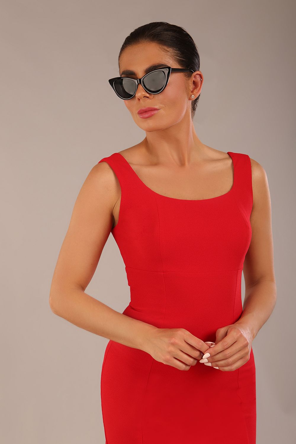 brunette model is wearing a diva catwalk Perthshire Sleeveless Bodycon Pencil Dress square neckline in passion red colour front image close up with sunglasses