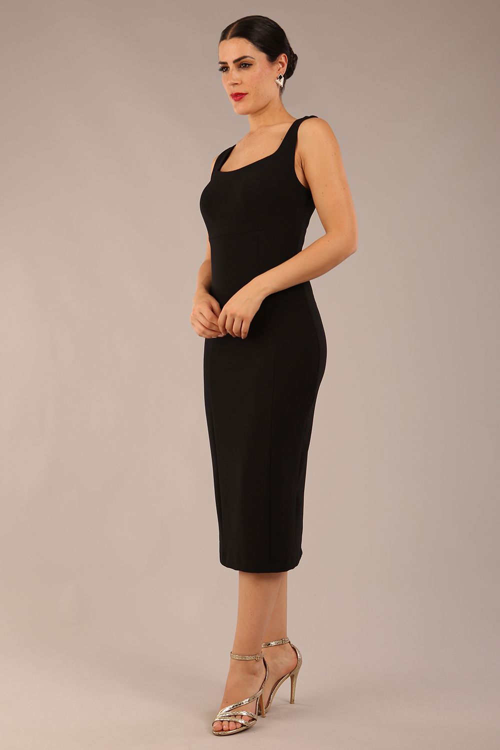 brunette model is wearing a diva catwalk Perthshire Sleeveless Bodycon Pencil Dress square neckline in black colour front image 