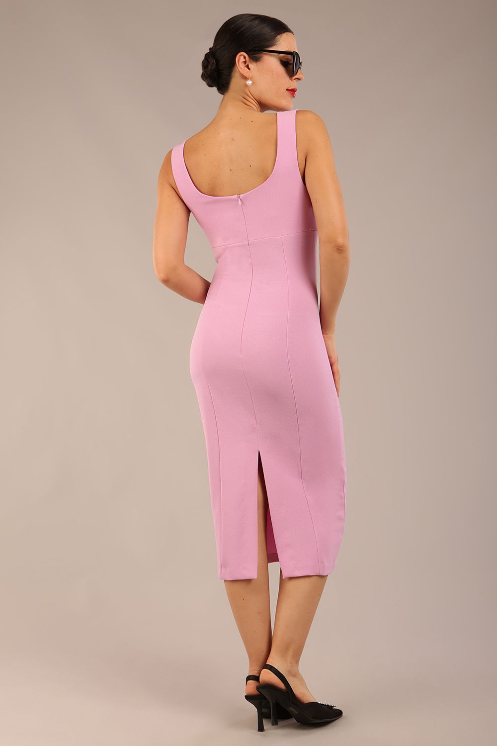 brunette model is wearing a diva catwalk Perthshire Sleeveless Bodycon Pencil Dress square neckline in dawn pink colour back image 