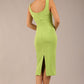brunette model is wearing a diva catwalk Perthshire Sleeveless Bodycon Pencil Dress square neckline in lime green colour back image 