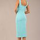 brunette model is wearing a diva catwalk Perthshire Sleeveless Bodycon Pencil Dress square neckline in turquoise colour back image 