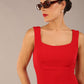 brunette model is wearing a diva catwalk Perthshire Sleeveless Bodycon Pencil Dress square neckline in Passion Red colour front image 