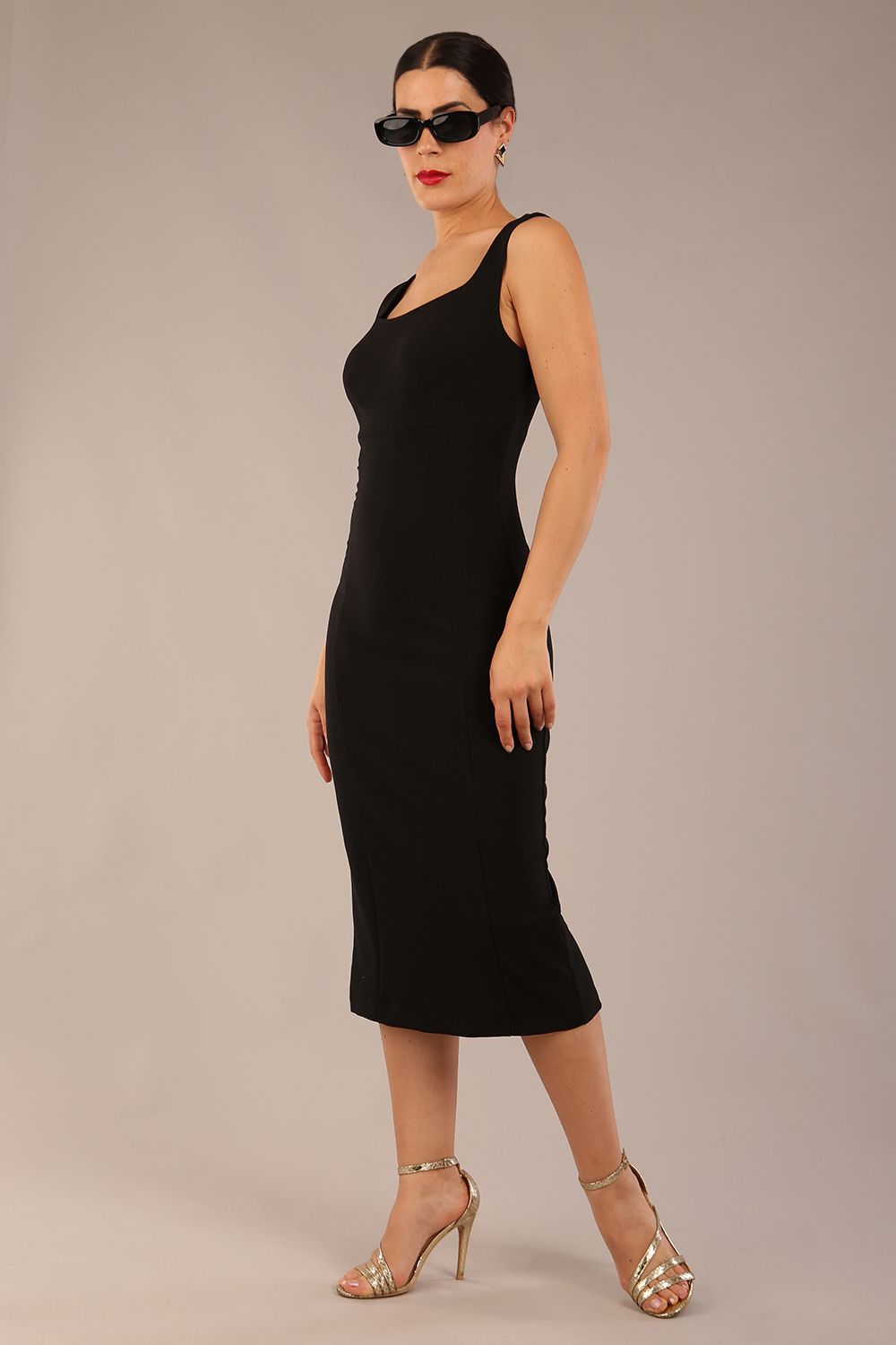brunette model is wearing a diva catwalk Perthshire Sleeveless Bodycon Pencil Dress square neckline in black colour back image 