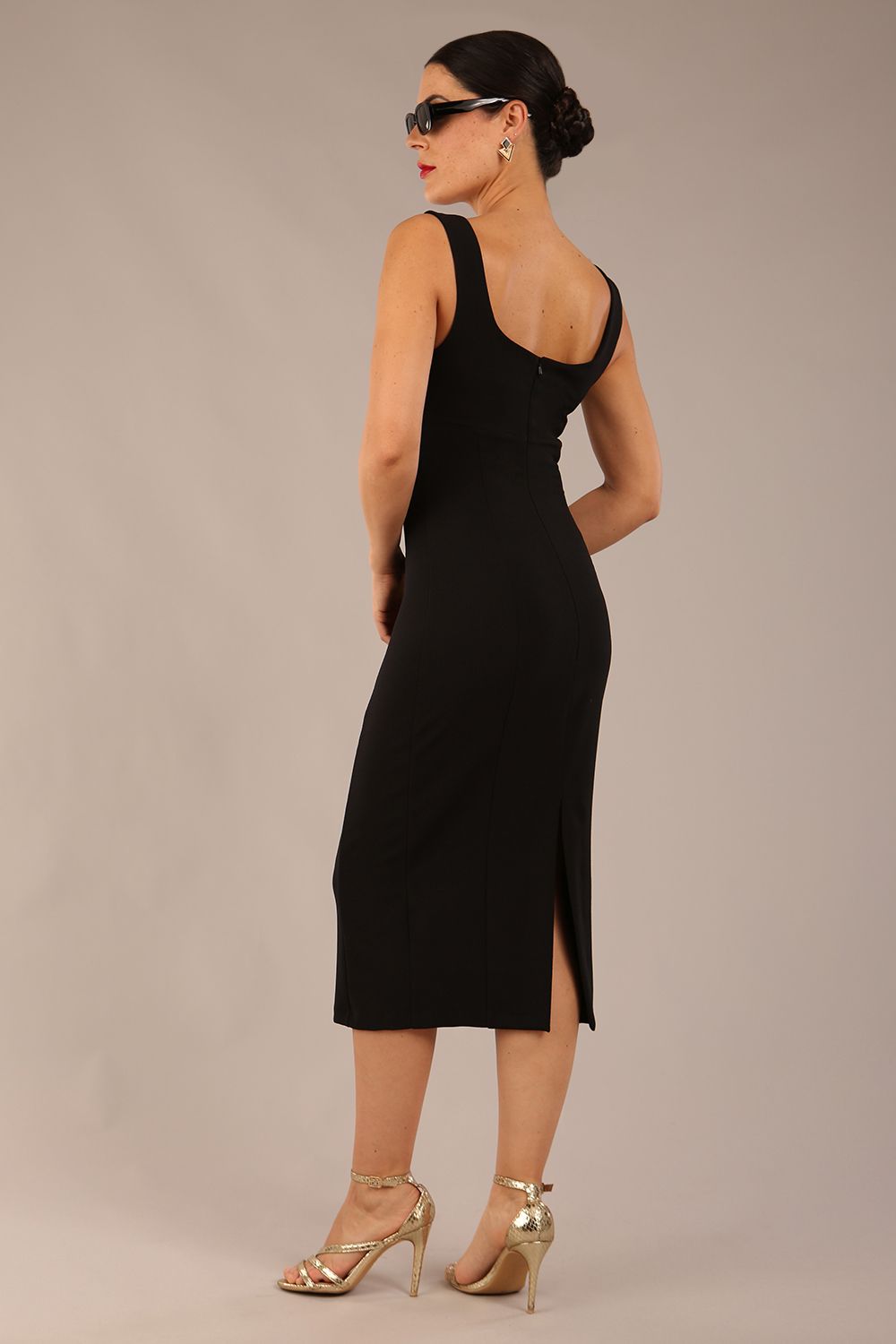 brunette model is wearing a diva catwalk Perthshire Sleeveless Bodycon Pencil Dress square neckline in black colour back image 