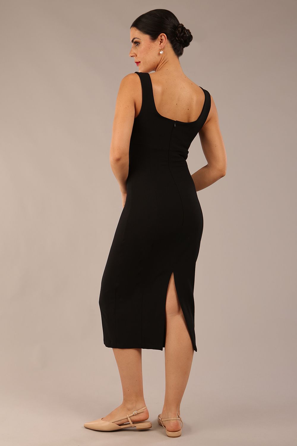 brunette model is wearing a diva catwalk Perthshire Sleeveless Bodycon Pencil Dress square neckline in black colour back image 