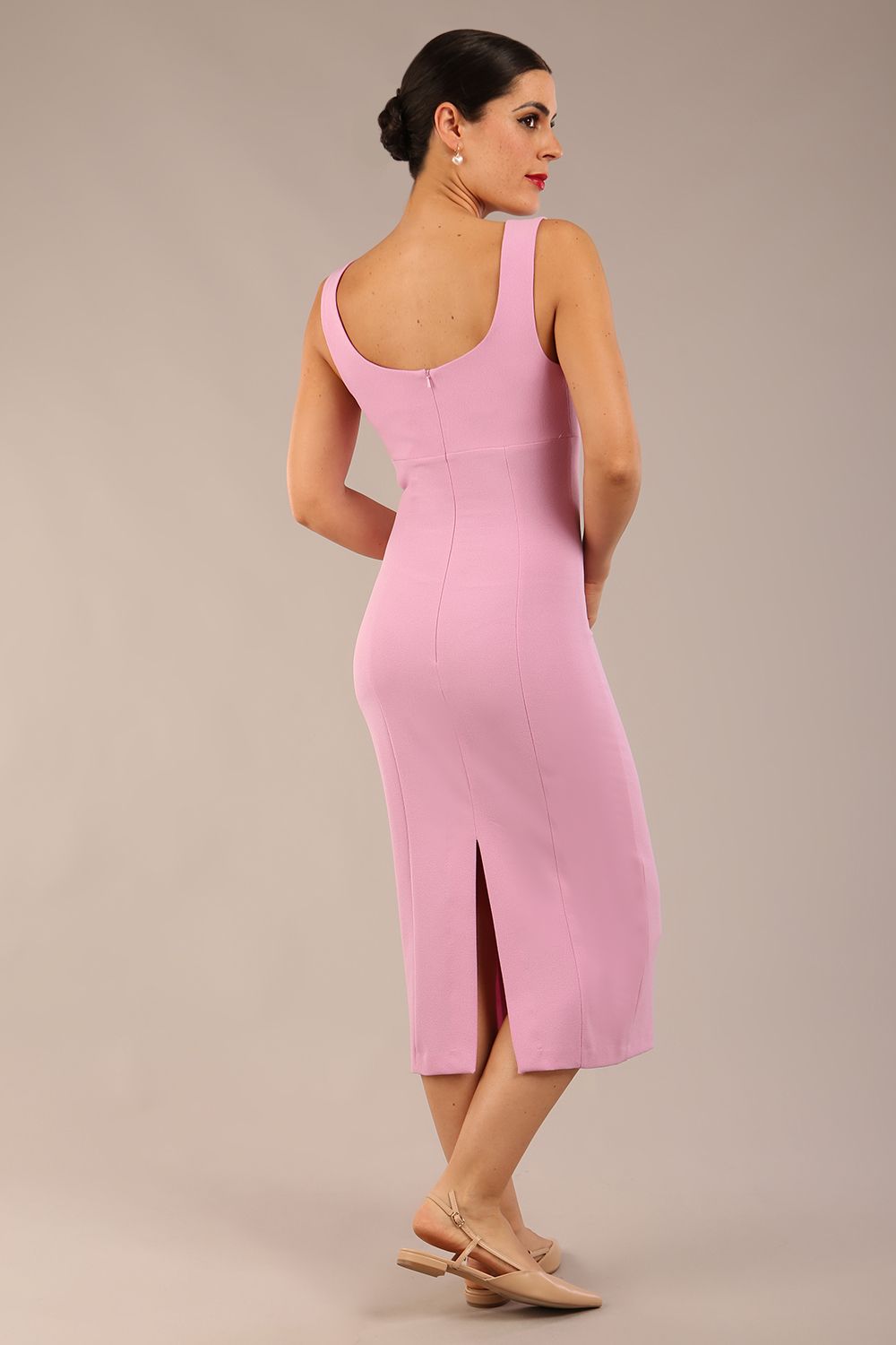 brunette model is wearing a diva catwalk Perthshire Sleeveless Bodycon Pencil Dress square neckline in dawn pink colour back image 