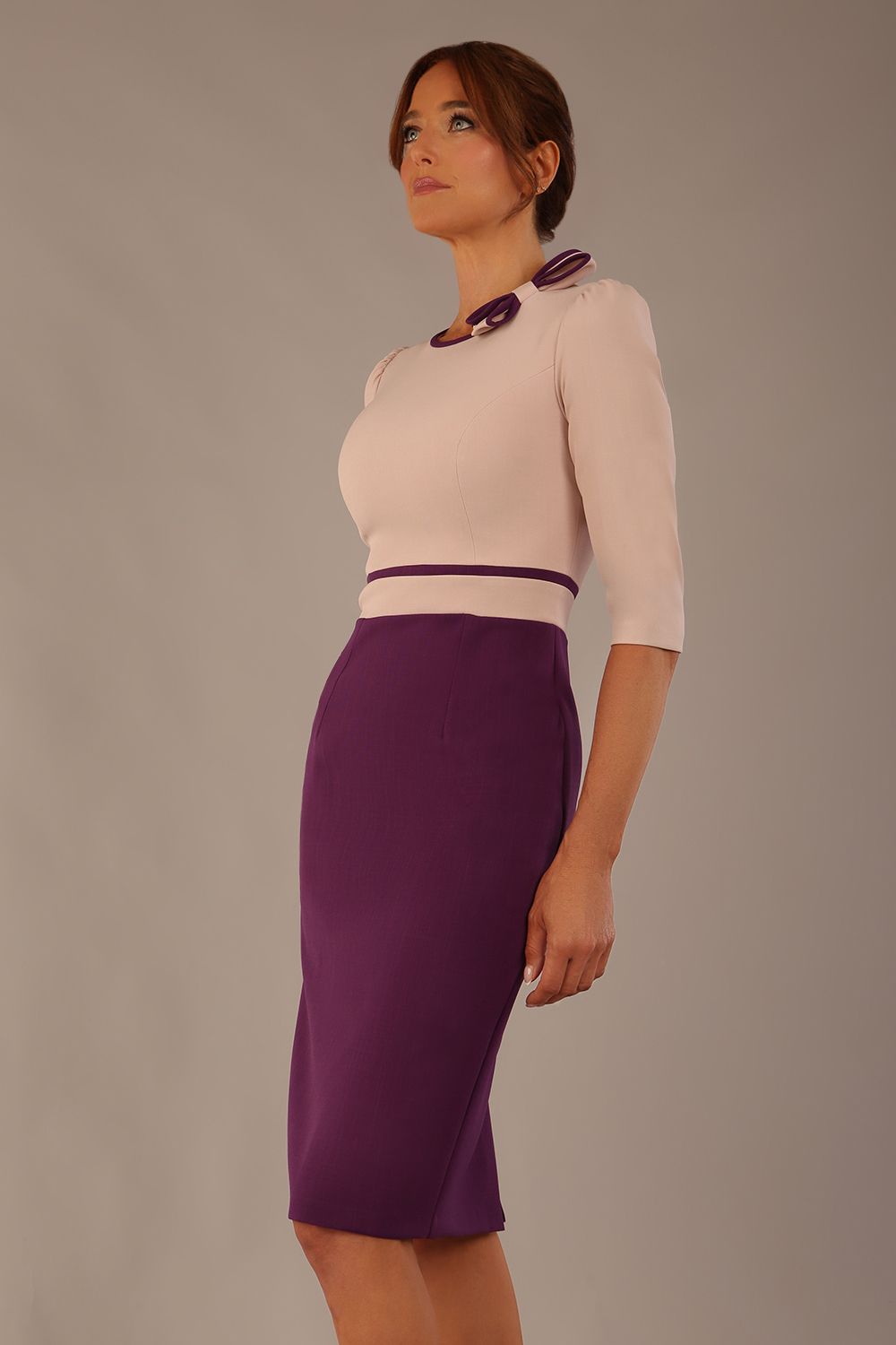 brunette model is wearing a diva catwalk Cherie Sleeved Contrast Bow Neck Pencil Dress round neckline  in Purple and Pink Haze front image