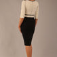 brunette model is wearing a diva catwalk Cherie Sleeved Contrast Bow Neck Pencil Dress round neckline  in Black and Stone back image