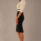 brunette model is wearing a diva catwalk Cherie Sleeved Contrast Bow Neck Pencil Dress round neckline  in Black and Stone front side image