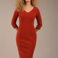 blonde model is wearing a  diva catwalk Tara V-neckline Sleeved Pencil Dress knee length in terracotta brown colour front image (Terracotta)