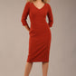 blonde model is wearing a  diva catwalk Tara V-neckline Sleeved Pencil Dress knee length in terracotta brown colour front image (Terracotta)