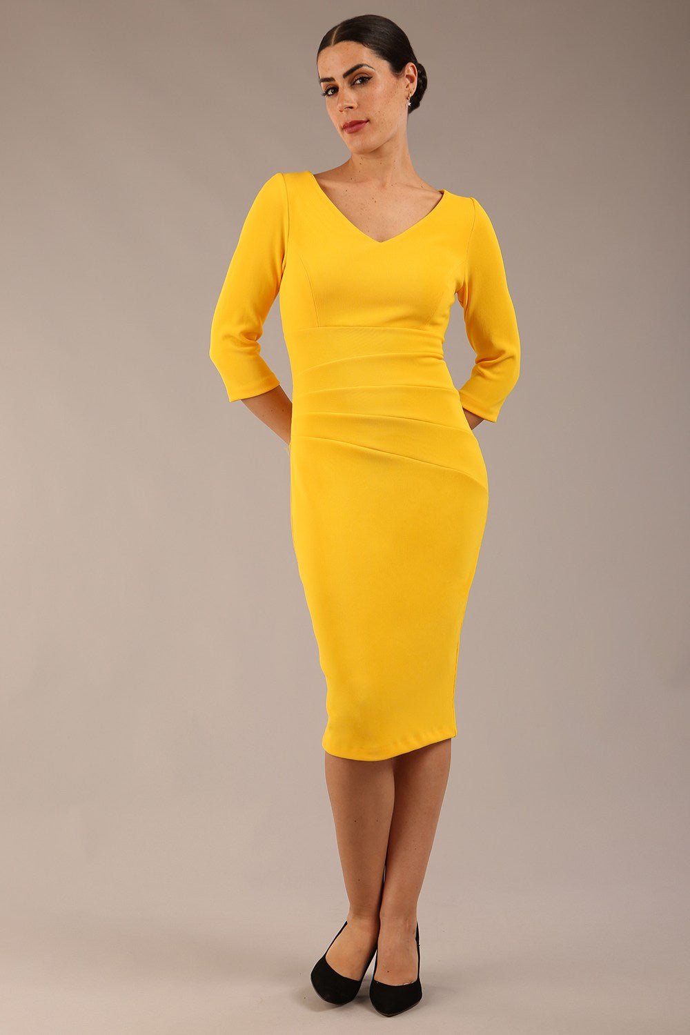 brunette model is wearing a  diva catwalk Tara V-neckline Sleeved Pencil Dress knee length in sunshine yellow colour front image 
