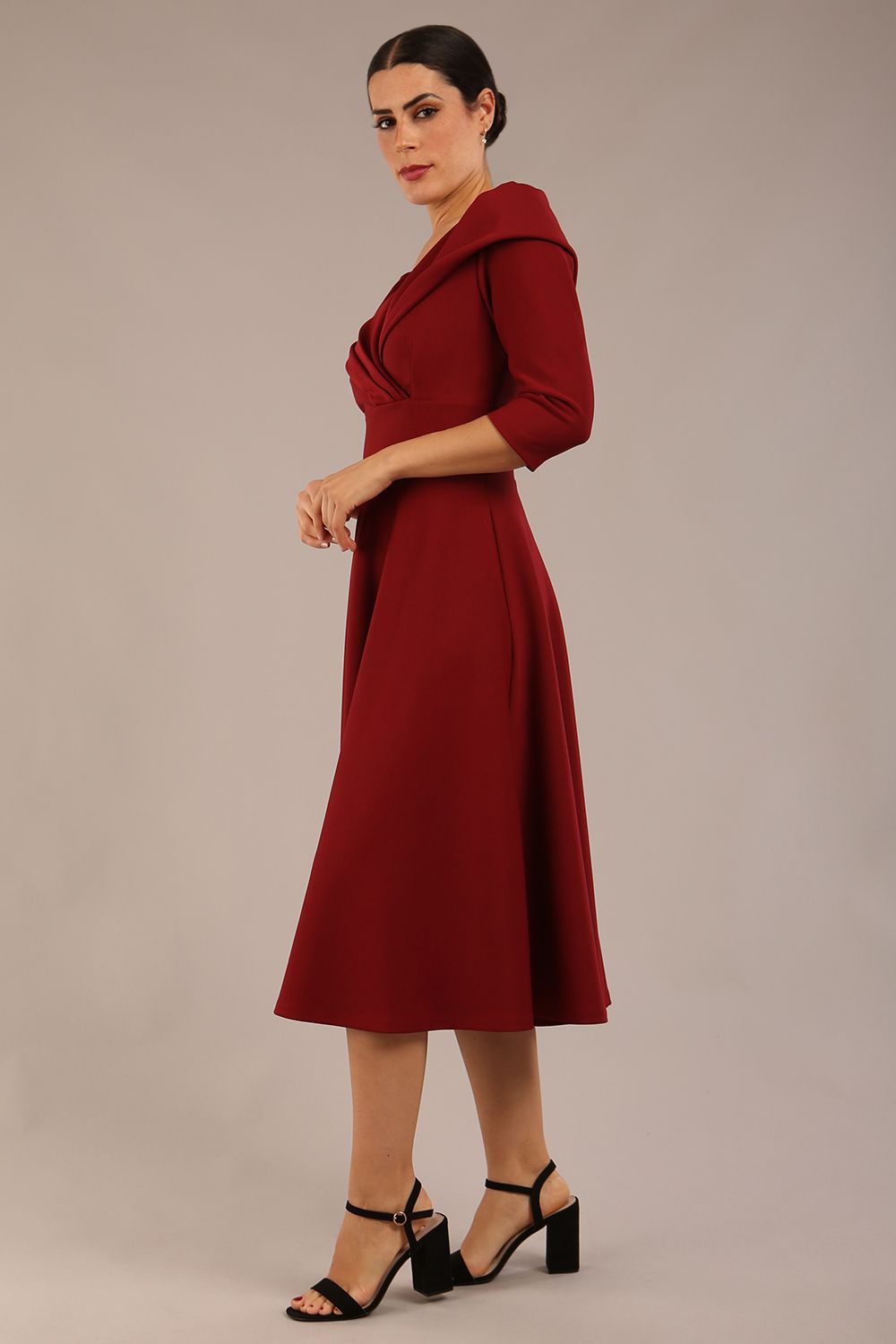 brunette model is wearing a diva catwalk Fabienne sleeved A-line Dress with pockets v neckline knee length wide waistband fold over v neckline in burgundy colour front image