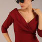 brunette model is wearing a diva catwalk Fabienne sleeved A-line Dress with pockets v neckline knee length wide waistband fold over v neckline in burgundy colour front image close up