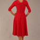 brunette model is wearing a diva catwalk Fabienne sleeved A-line Dress with pockets v neckline knee length wide waistband fold over v neckline in electric red colour back image