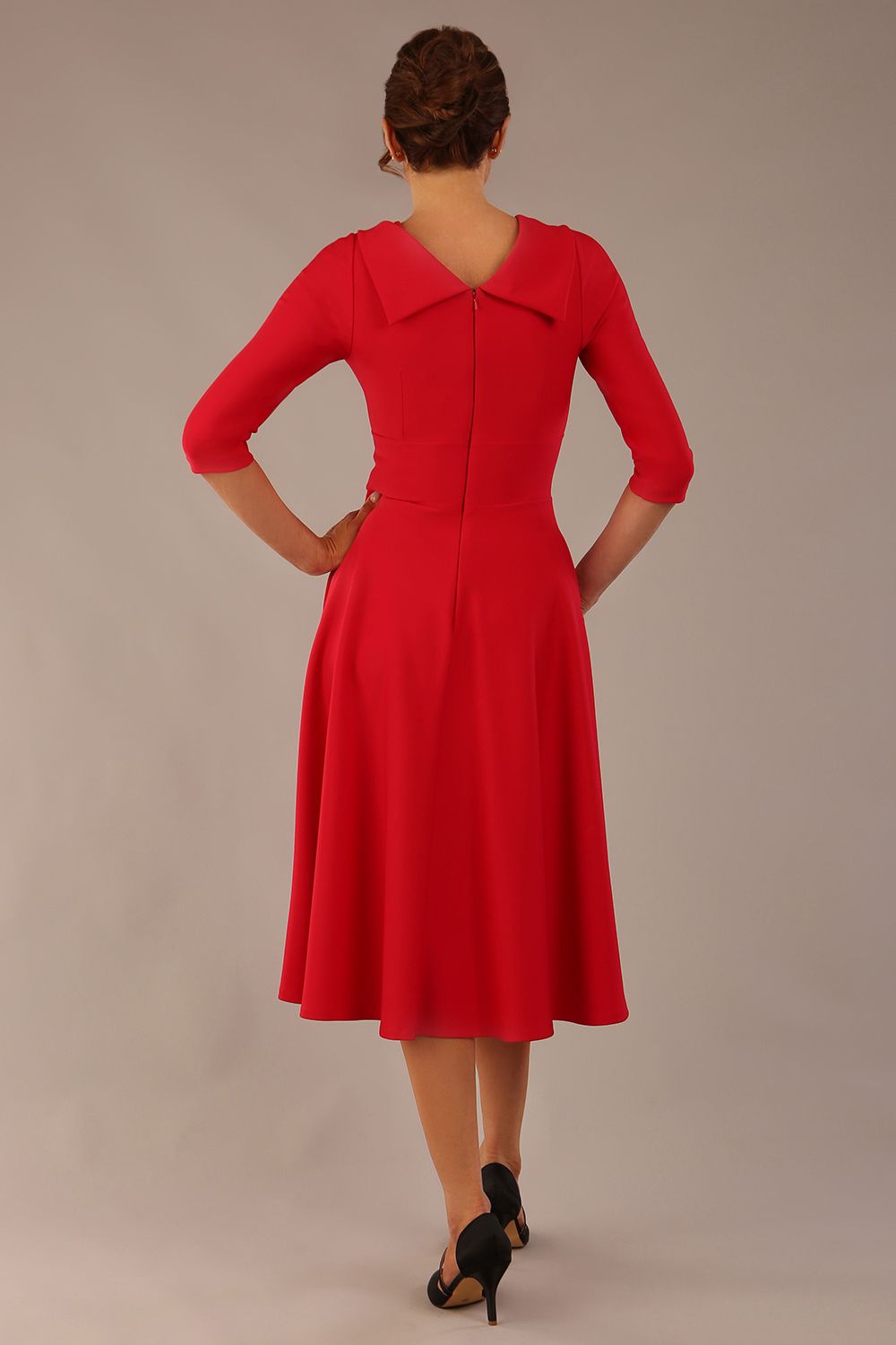 brunette model is wearing a diva catwalk Fabienne sleeved A-line Dress with pockets v neckline knee length wide waistband fold over v neckline in electric red colour back image