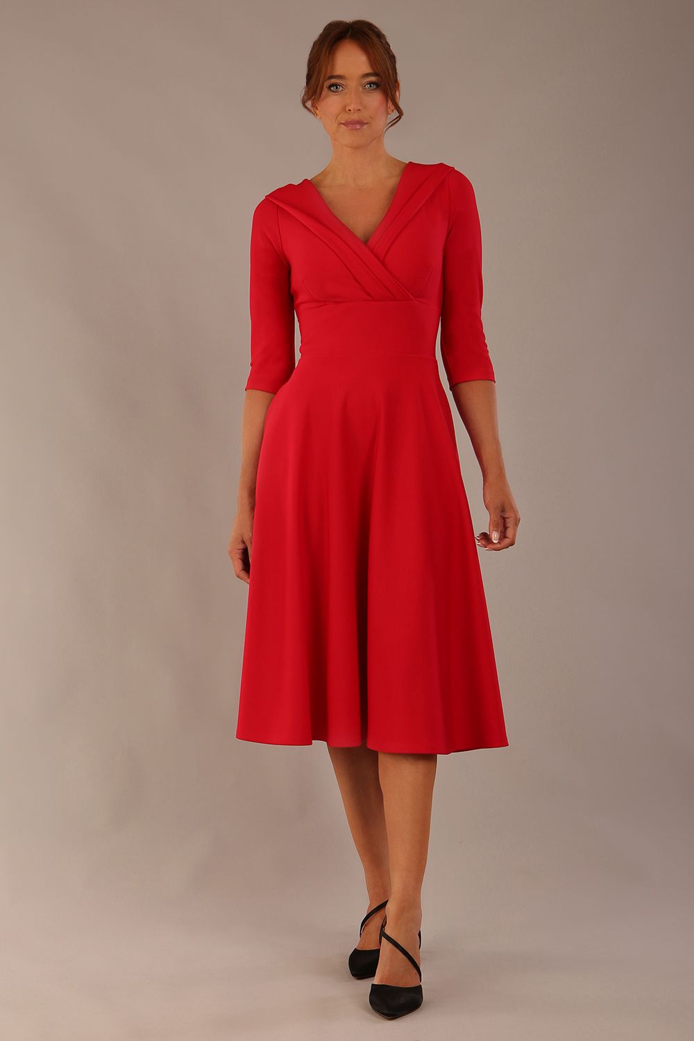 brunette model is wearing a diva catwalk Fabienne sleeved A-line Dress with pockets v neckline knee length wide waistband fold over v neckline in electric red colour front image