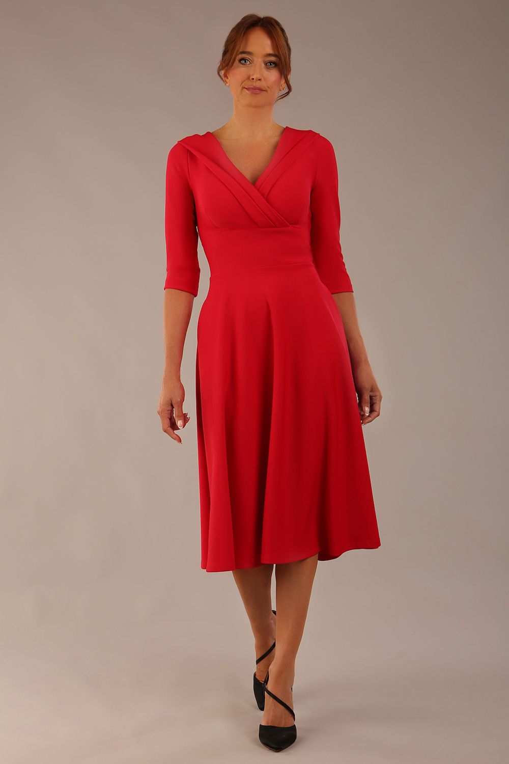 brunette model is wearing a diva catwalk Fabienne sleeved A-line Dress with pockets v neckline knee length wide waistband fold over v neckline in electric red colour front image