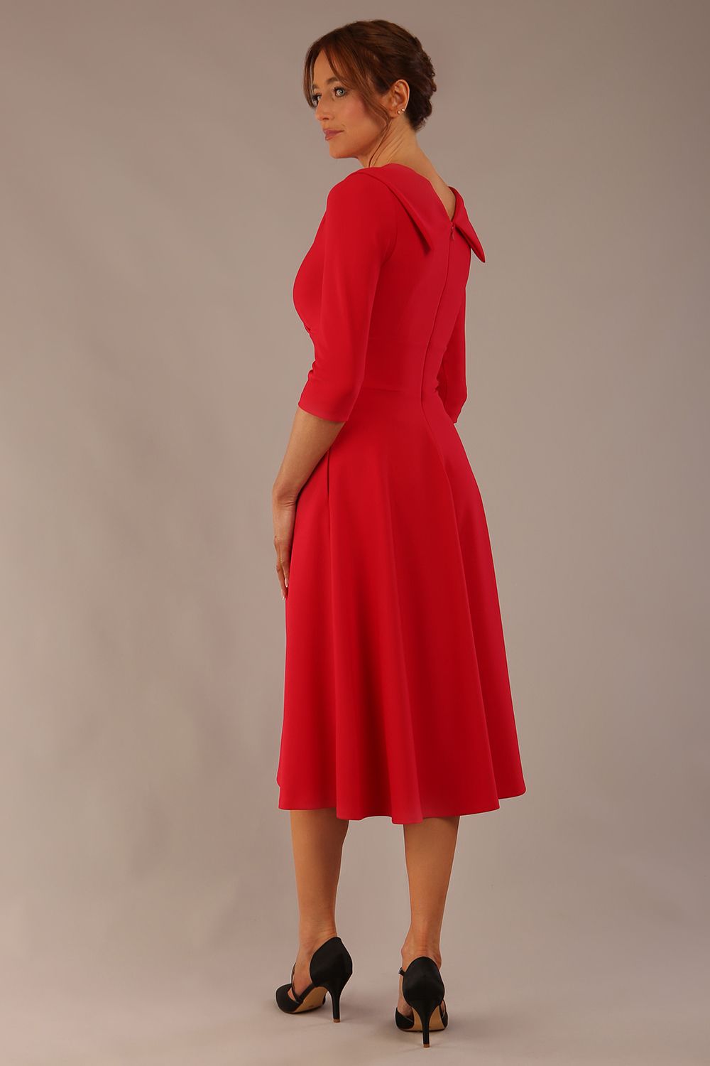 brunette model is wearing a diva catwalk Fabienne sleeved A-line Dress with pockets v neckline knee length wide waistband fold over v neckline in electric red colour back image