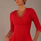 brunette model is wearing a diva catwalk Fabienne sleeved A-line Dress with pockets v neckline knee length wide waistband fold over v neckline in electric red colour front image close up