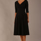 brunette model is wearing a diva catwalk Fabienne sleeved A-line Dress with pockets v neckline knee length wide waistband fold over v neckline in black colour front image