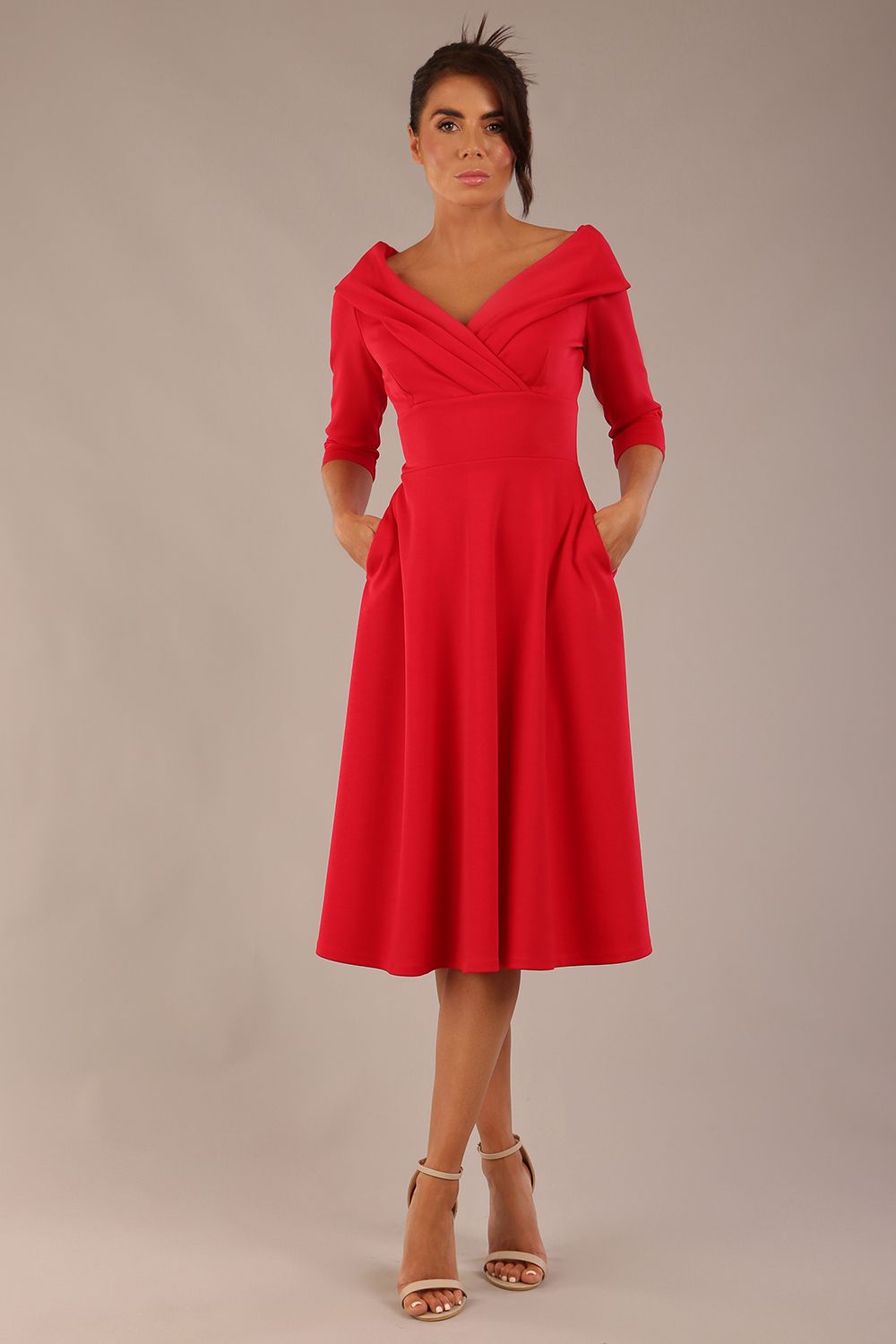 brunette model is wearing a diva catwalk Fabienne sleeved A-line Dress with pockets v neckline knee length wide waistband fold over v neckline in electric red colour front image