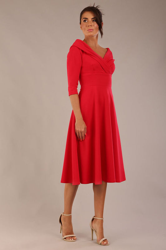 brunette model is wearing a diva catwalk Fabienne sleeved A-line Dress with pockets v neckline knee length wide waistband fold over v neckline in electric red colour front side image