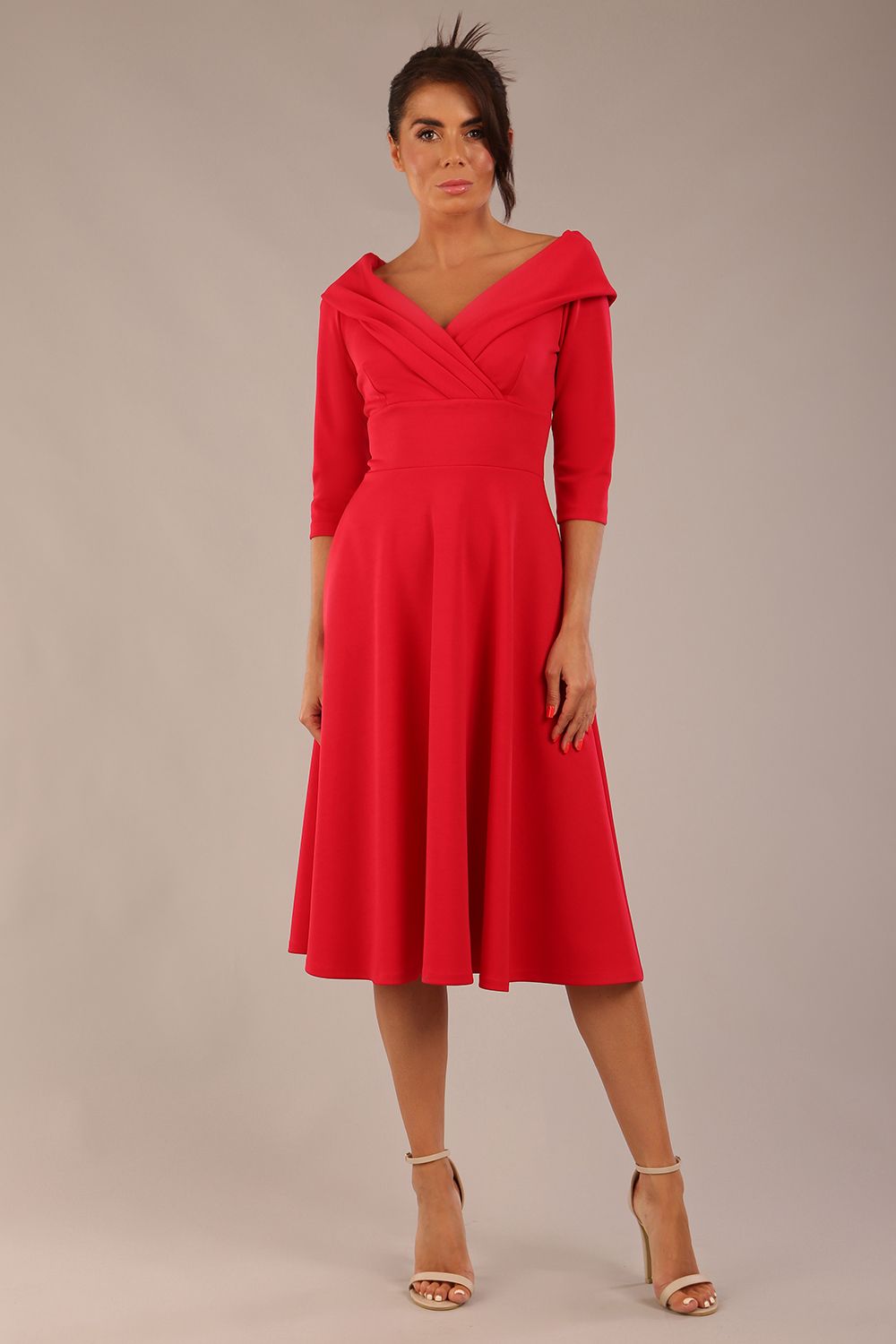 brunette model is wearing a diva catwalk Fabienne sleeved A-line Dress with pockets v neckline knee length wide waistband fold over v neckline in electric red colour front image