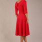 brunette model is wearing a diva catwalk Fabienne sleeved A-line Dress with pockets v neckline knee length wide waistband fold over v neckline in electric red colour back image