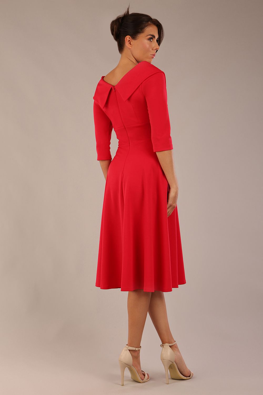 brunette model is wearing a diva catwalk Fabienne sleeved A-line Dress with pockets v neckline knee length wide waistband fold over v neckline in electric red colour back image