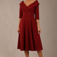 brunette model is wearing a diva catwalk Fabienne sleeved A-line Dress with pockets v neckline knee length wide waistband fold over v neckline in burgundy colour front image