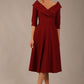 brunette model is wearing a diva catwalk Fabienne sleeved A-line Dress with pockets v neckline knee length wide waistband fold over v neckline in burgundy colour front image