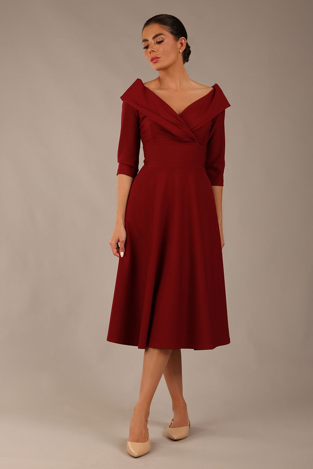 brunette model is wearing a diva catwalk Fabienne sleeved A-line Dress with pockets v neckline knee length wide waistband fold over v neckline in burgundy colour front image
