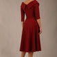 brunette model is wearing a diva catwalk Fabienne sleeved A-line Dress with pockets v neckline knee length wide waistband fold over v neckline in burgundy colour back image