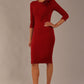 brunette model is wearing a diva catwalk Mirabelle ¾ Sleeves & Floral Shoulder Detail Pencil Dress with diagonal pleating across the front knee length in rosewood red colour front image