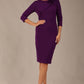brunette model is wearing a diva catwalk Mirabelle ¾ Sleeves & Floral Shoulder Detail Pencil Dress with diagonal pleating across the front knee length in purple colour front image
