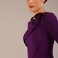 brunette model is wearing a diva catwalk Mirabelle ¾ Sleeves & Floral Shoulder Detail Pencil Dress with diagonal pleating across the front knee length in purple colour front image close up