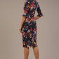 back view Model wearing the Portofino frill neck floral jacquard dress against a plain background (Hidcote Floral)
