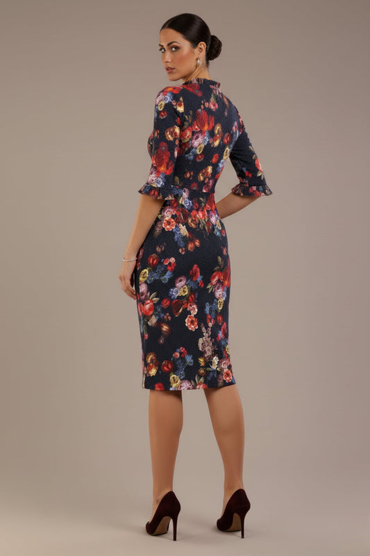 back view Model wearing the Portofino frill neck floral jacquard dress against a plain background (Hidcote Floral)