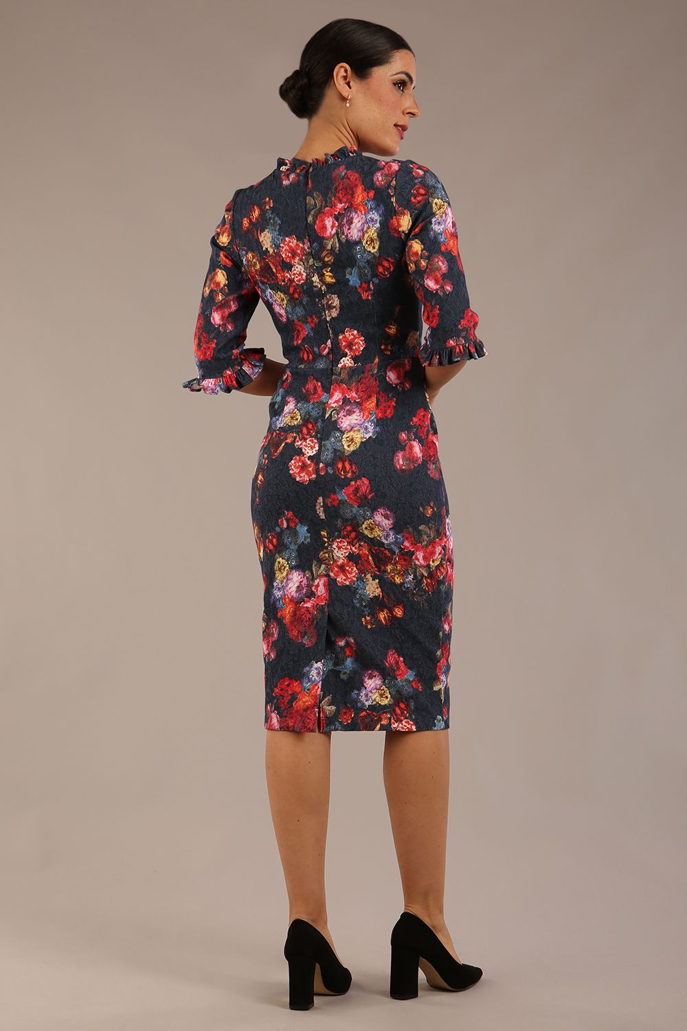 back view Model wearing the Portofino frill neck floral jacquard dress against a plain background (Hidcote Floral)
