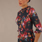 close up Model wearing the Portofino frill neck floral jacquard dress against a plain background (Hidcote Floral)