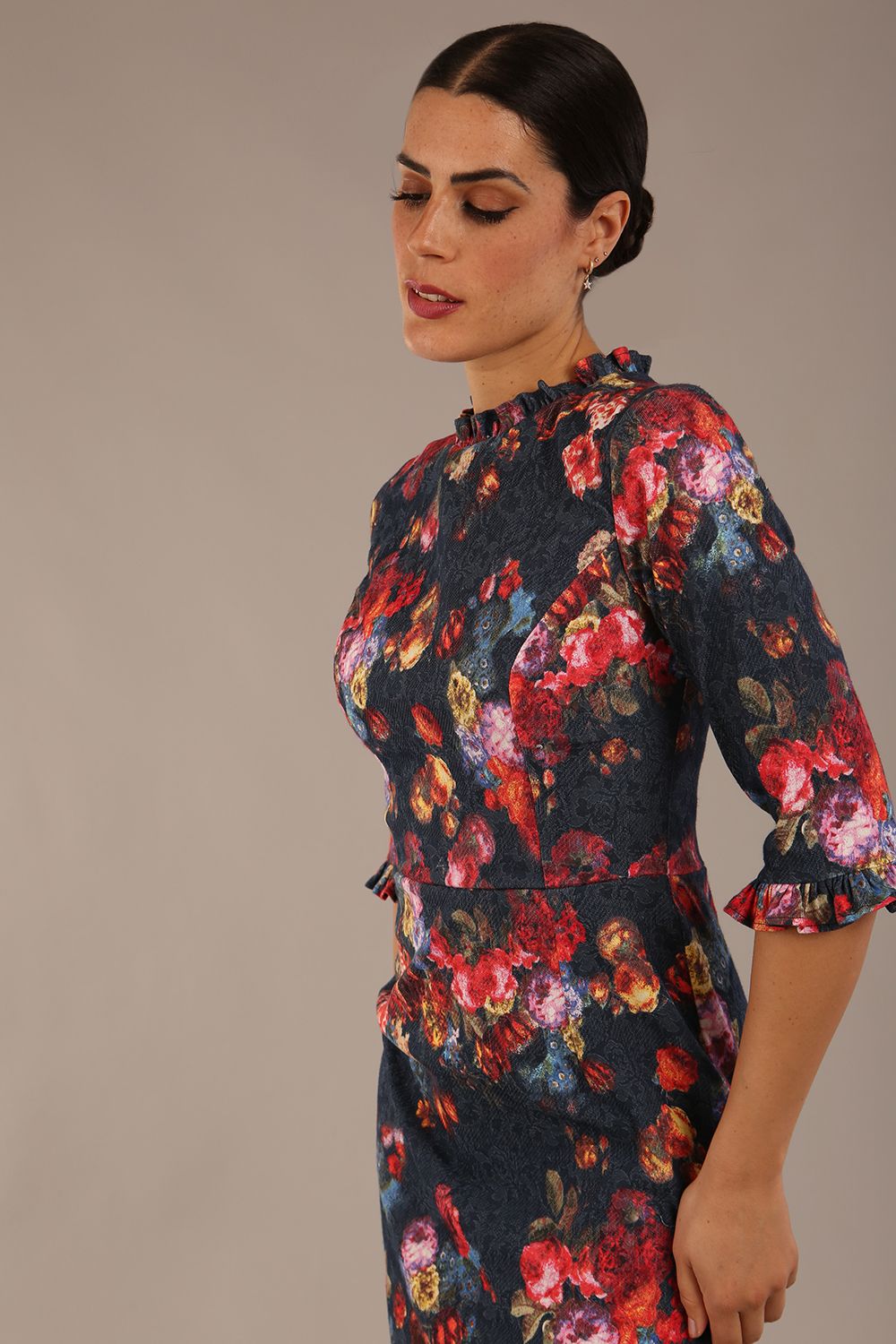 close up Model wearing the Portofino frill neck floral jacquard dress against a plain background (Hidcote Floral)